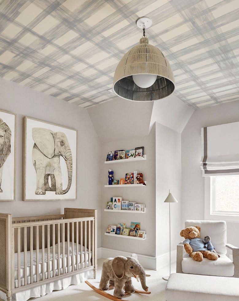 Furniture and artwork above the crib were sourced from RH, ceiling wallpaper from Porter Teleo and the lighting fixture from Bone Simple in the nursery. PHOTOGRAPHED BY RIKKI SNYDER
