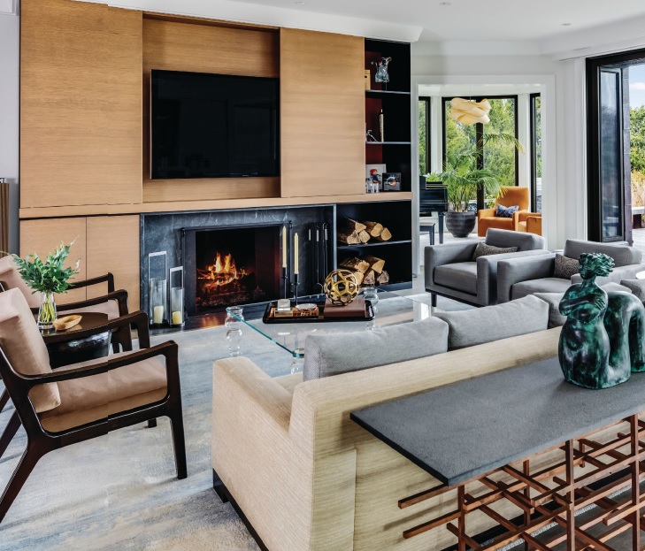 The family room delivers comfort and style, with a television that can be concealed when not in use by the family. Photographed by Greg Premru