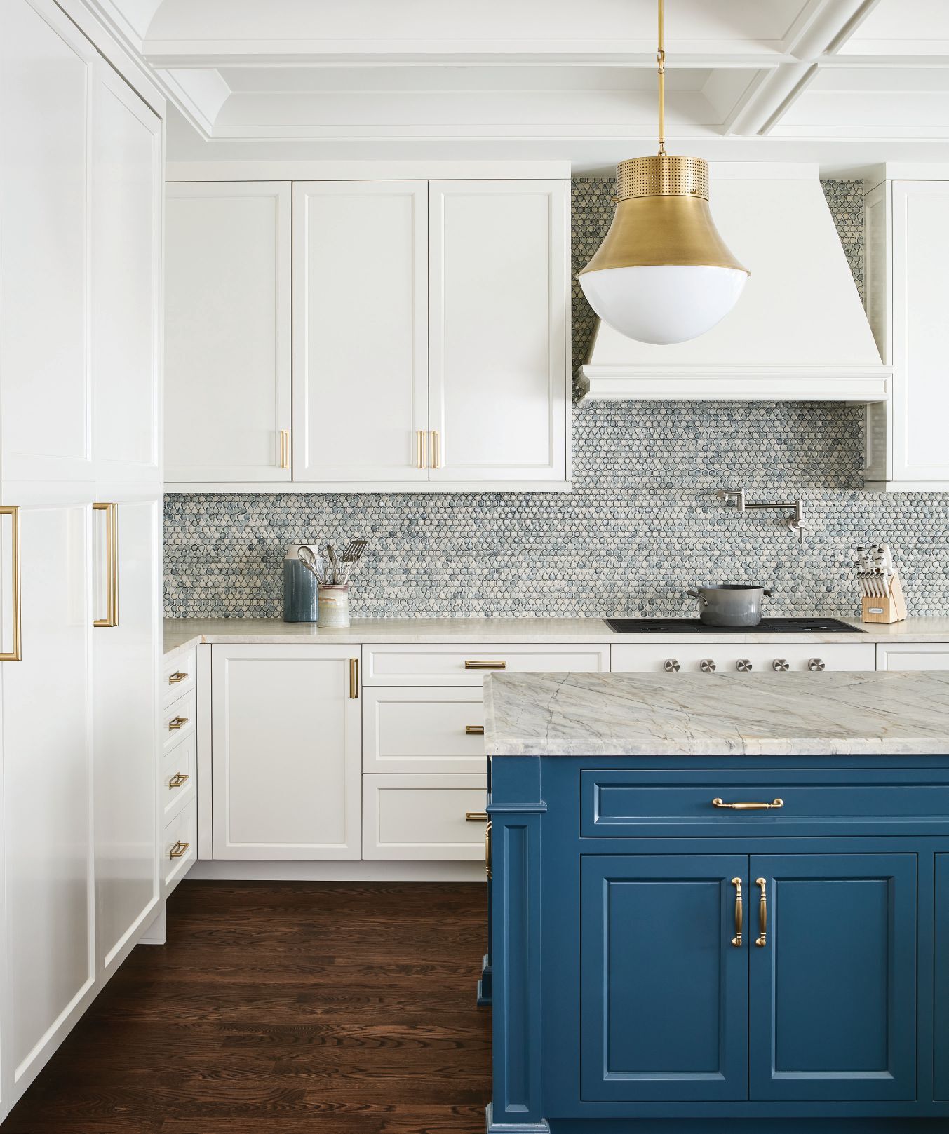 Custom backsplash tile by The Fine Line, Precision large pendant lights by Visual Comfort and island cabinets painted in Farrow & Ball’s striking Hague Blue make the kitchen pop.  Photographed by Ryan McDonald