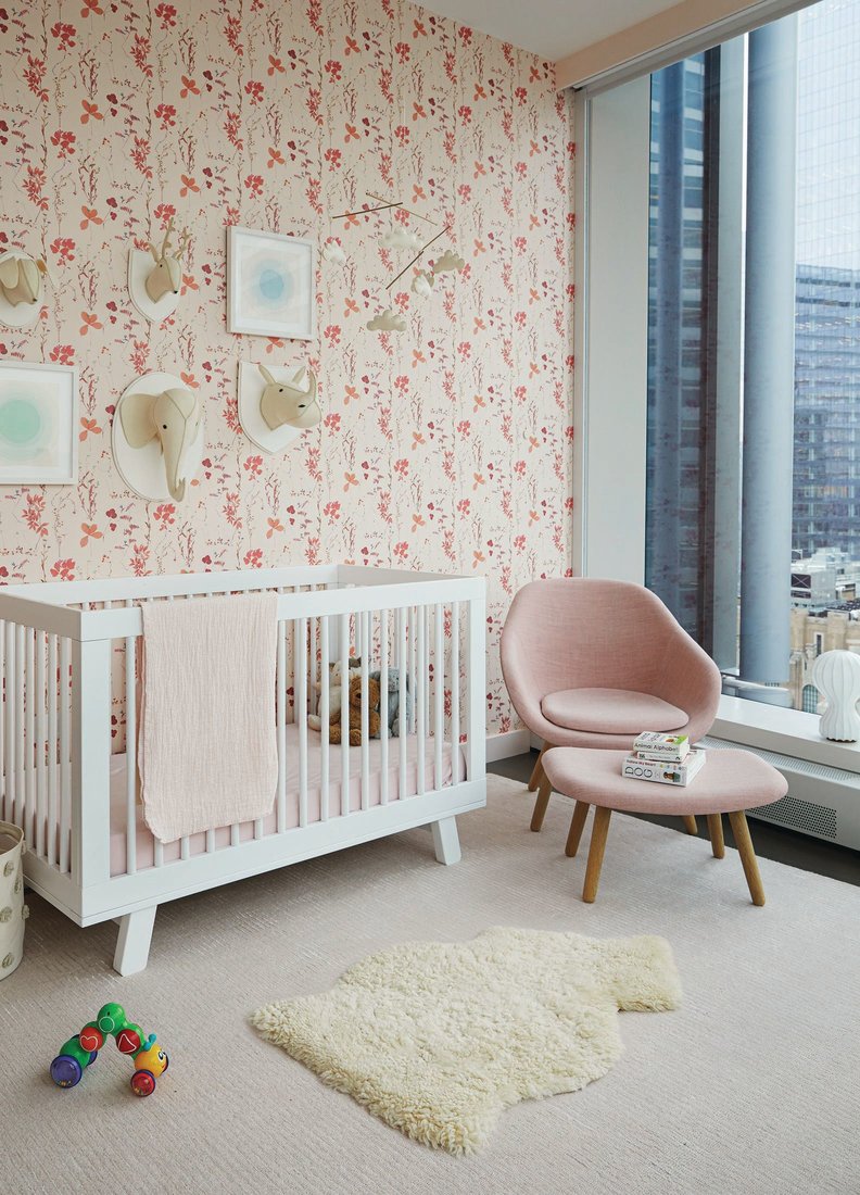 In the nursery, a Shea Shadowstripe rug from RH Baby & Child, Aimée Wilder Herbario wallpaper and About A lounge chair and ottoman by HAY upholstered in Maharam canvas fabric Photographed by Sharon Radisch