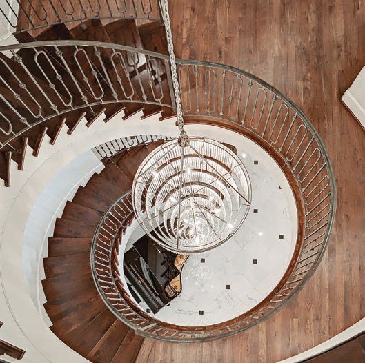The spiral staircase provides the perfect bird’s-eye view of the grand piano PHOTO COURTESY OF COMPASS