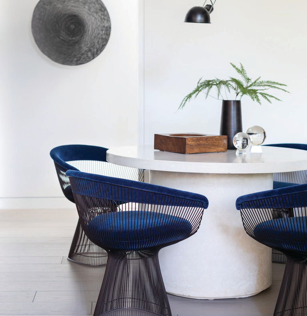 In the open living room, a Bradley Hughes bone concrete table paired with Knoll Warren Platner dining chairs beckons Photographed by Aimée Mazzenga