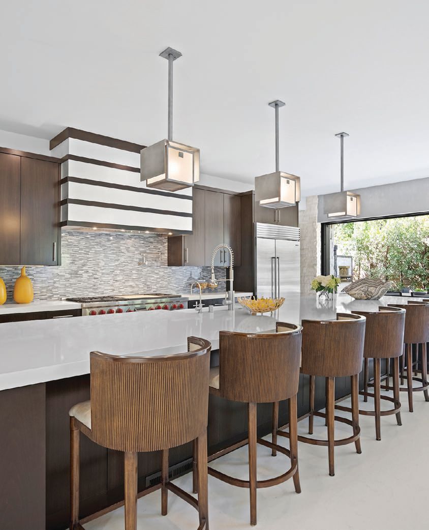 The kitchen of this Newport Beach stunner flaunts an oversize island PHOTO COURTESY OF MEITAL TAUB LUXURY GROUP
