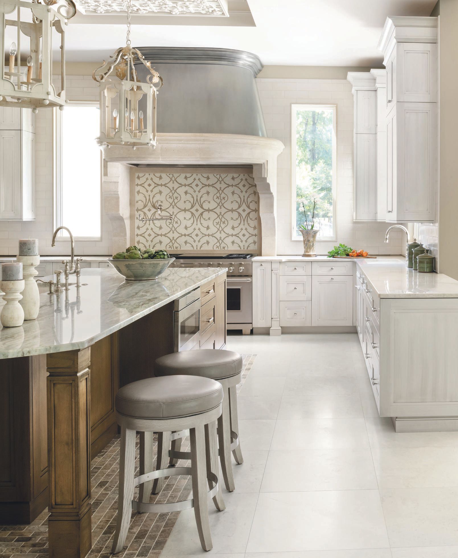 A plaster ceiling relief by Ornamental Plaster Works, white floors and cabinetry, and neutral tilework give this kitchen a bright, inviting feel. PHOTO BY ROBERT RADIFERA; STYLING BY CHARLOTTE SAFAVI