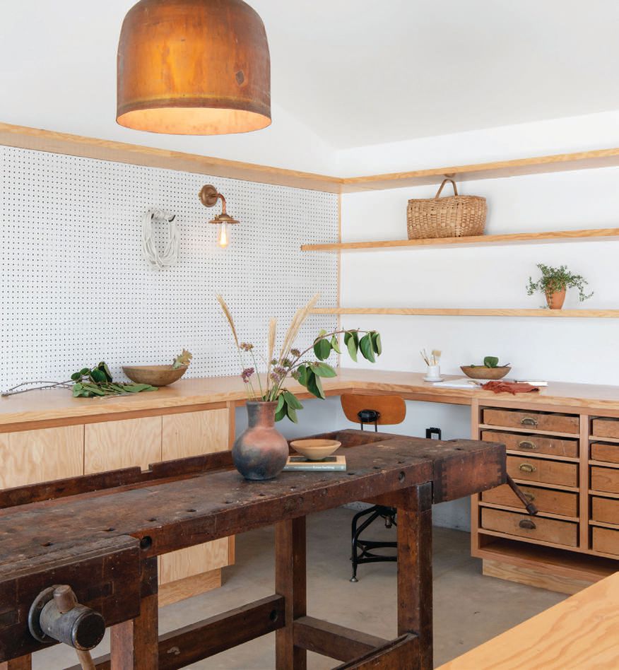 The art studio houses a worktable from Santa Ynez General nearby, along with
vintage bar stools found on 1stDibs. The copper pendant is vintage, while the sconces and pulley pendant are by Original BTC. PHOTOGRAPHED BY GAVIN CATER