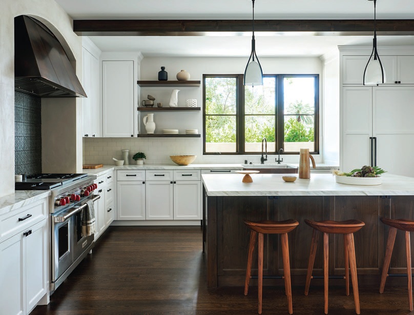 Holly Hunt pendants illuminate the kitchen, which is anchored by a Wolf range. PHOTOGRAPHED BY BRAD KNIPSTEIN