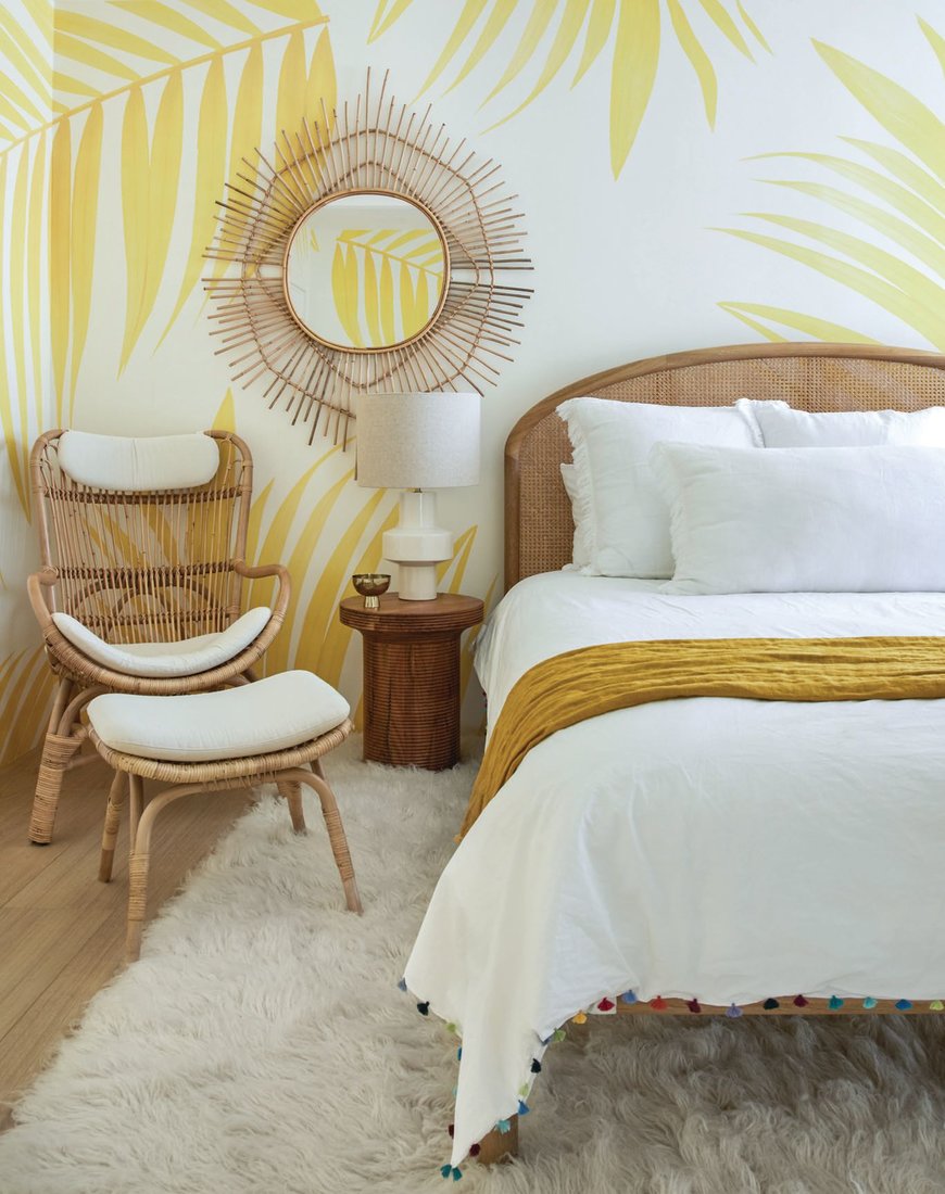 A sunny bedroom shines with a yellow palm print wallpaper from Hovia. PHOTOGRAPHED BY MADELINE TOLLE