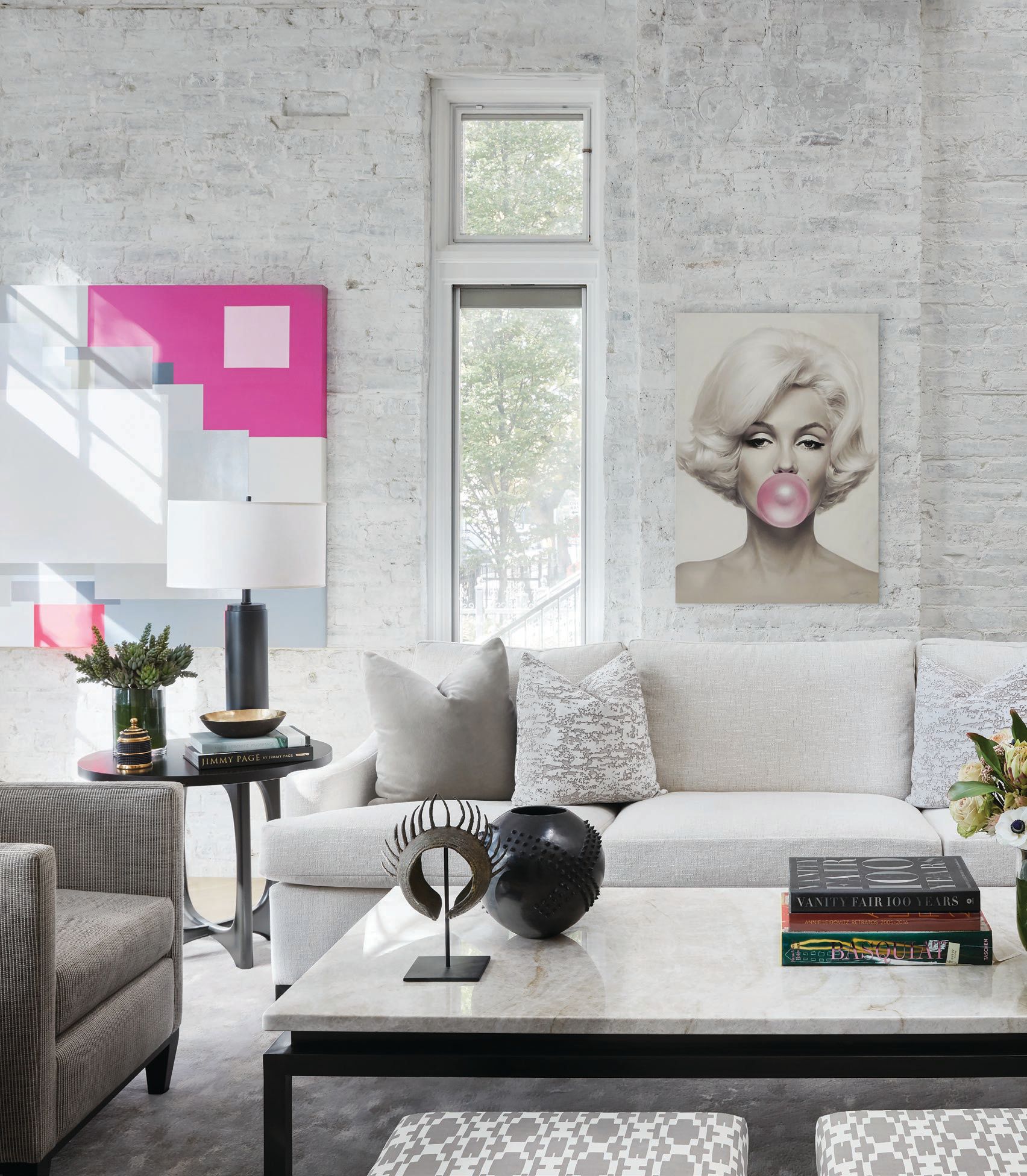 In the main living space (whose ceilings soar up to 30 feet), the works “Beverly Hills Woman” by Marco Casentini and “Marilyn Monroe Pink Bubble Gum” by Michael Moebius pop chicly against the room’s otherwise neutral tones. PHOTOGRAPHED BY DUSTIN HALLECK