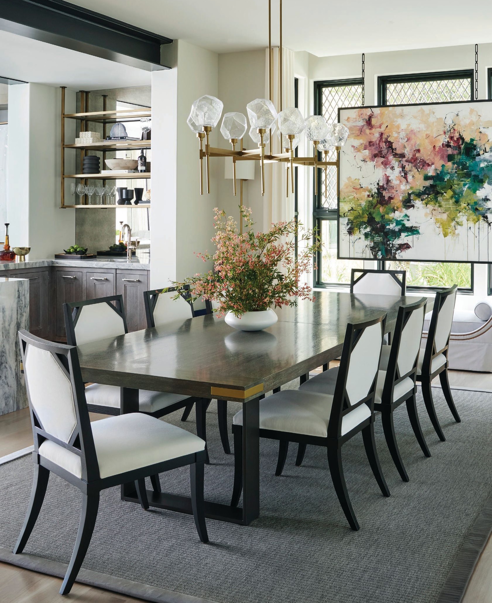 A custom hand-forged iron trestle table with metal corner details by deAurora takes pride of place in the dining room, which also features Hammerton Studio’s Gem linear chandelier and striking commissioned art piece “Beyond the Garden Gate” by Carlos Ramirez. Photographed by Werner Straube