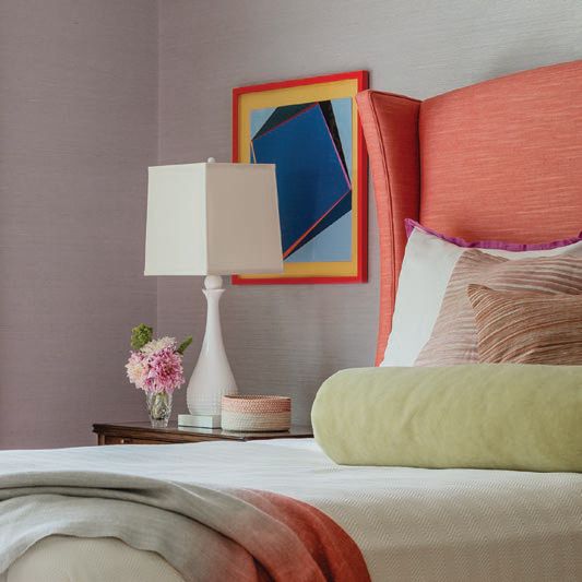 The daughter’s bedroom pops with a coral-hued bed. Photographed by Michael J. Lee