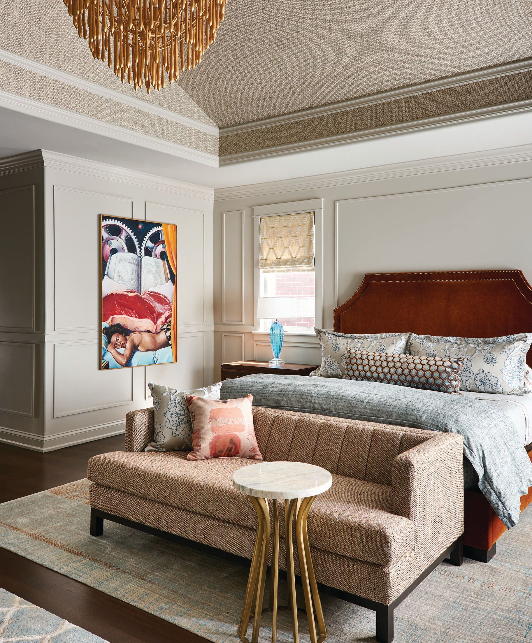 Phillip Jeffries’ Maldives Weave in Fauna covers the ceiling of the primary bedroom, which also features a custom settee by Kaufman Segal Design upholstered in Kravet’s Clarke & Clarke fabric in Louis Autumn; artwork by Peter Illig (peterillig.com); and a jarred marble side table by Palacek. Photographed by Ryan McDonald