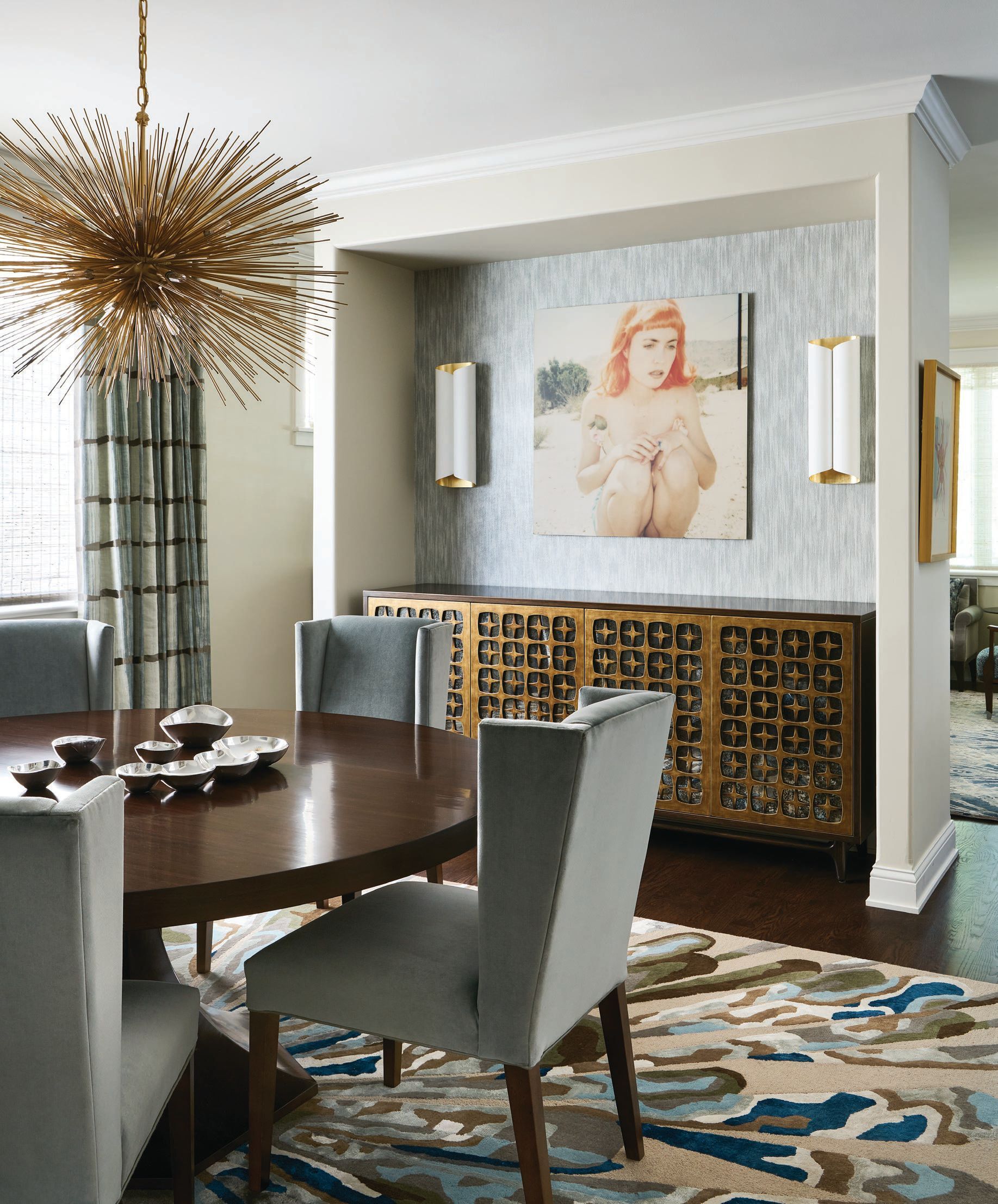 Visual Comfort’s Strada medium oval chandelier hangs chicly over
the custom table by Old Biscayne Designs and custom chairs by Pauline Grace in the dining room, which also features the client’s own artwork and Vinyl Stingray wallcovering by Phillip Jeffries purchased through Holly Hunt. Photographed by Ryan McDonald