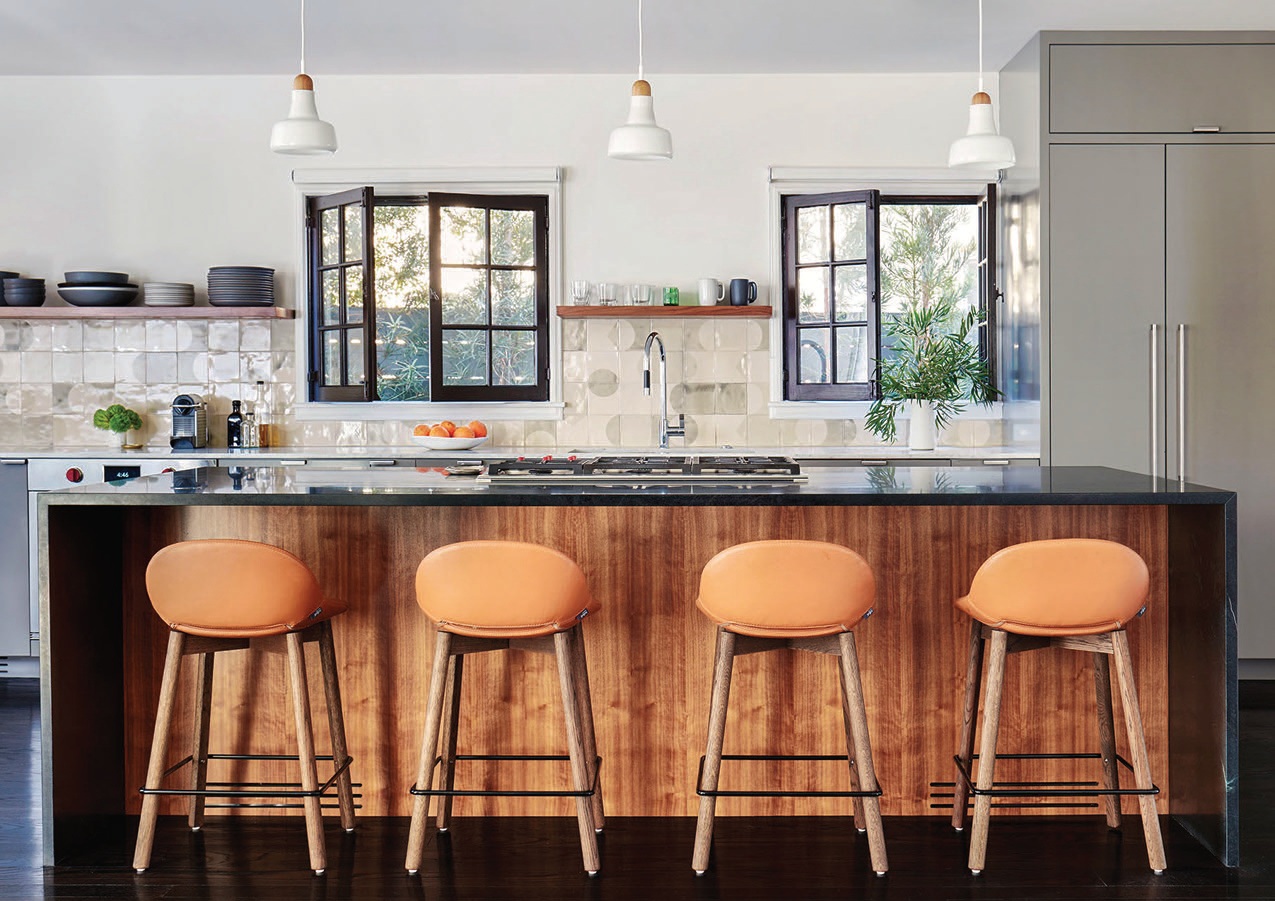 The open kitchen’s Beso bar stools invite guests to hang out around the soapstone island. Photographed by Trevor Tondro