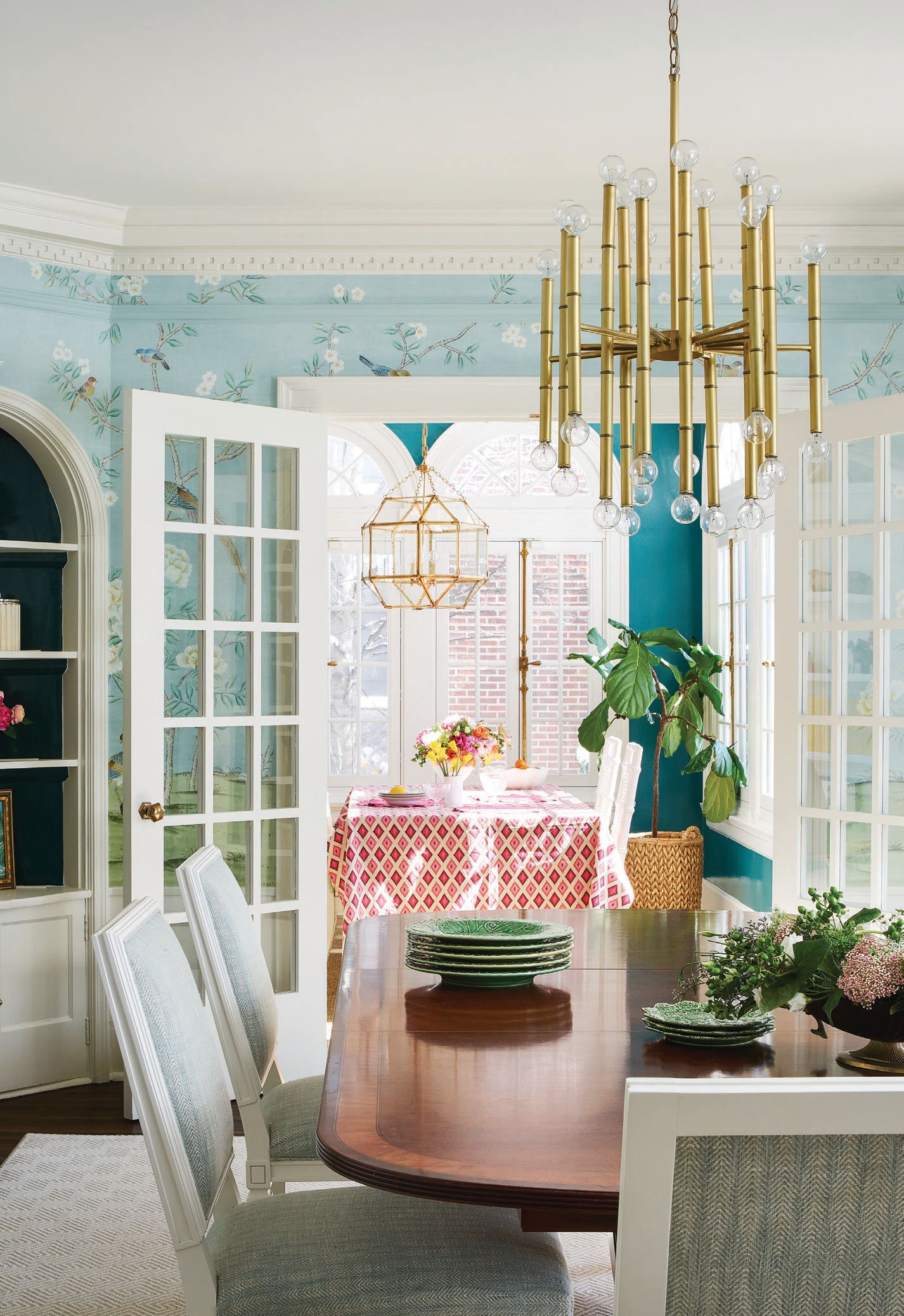 The light-filled dining room enchants with chinoiserie wallpaper by The Mural Source.