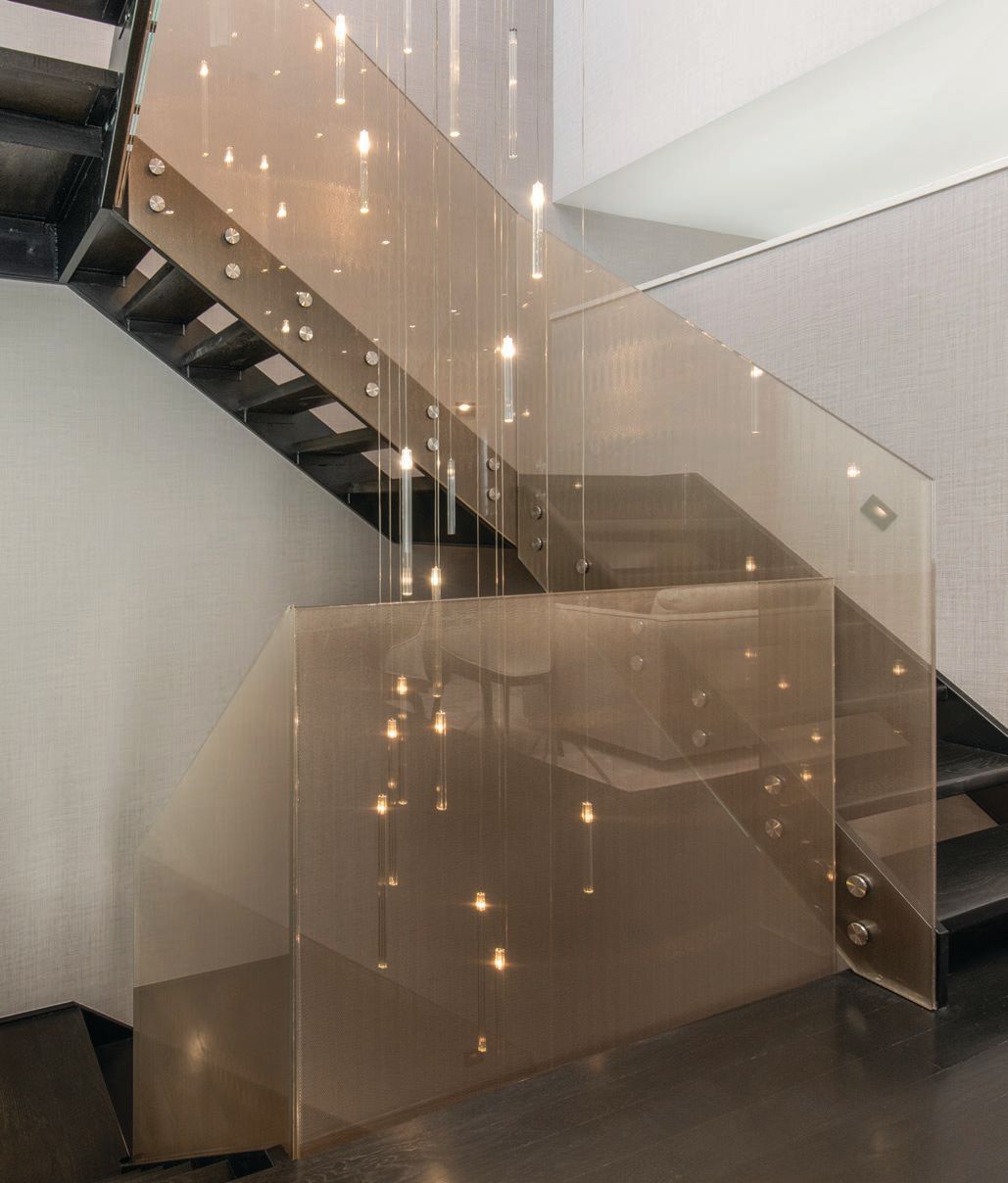 A delicate cascade of Reflex’s Comete Collezione lights illuminates the staircase. Photographed by Angelika Friday