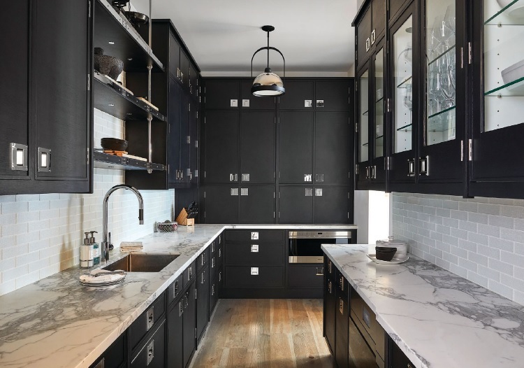 Polished metals pop against the dark cabinets in the back kitchen. PHOTO BY GENEVIEVE GARRUPPO