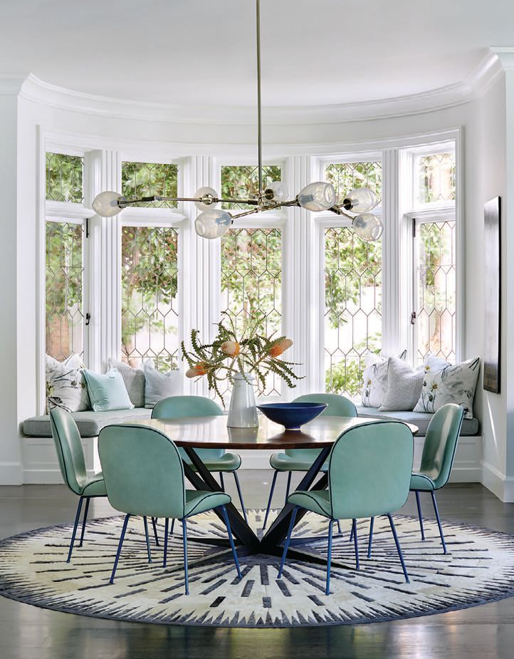 Chairs upholstered in sea foam Moore & Giles leather accentuate the light and airy breakfast nook. Photographed by Trevor Tondro