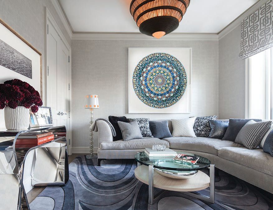 In the den, a Ralph Pucci coffee table, Patterson Flynn Martin rug and artwork by Damien Hirst PHOTO COURTESY OF ARTHUR DUNNAM INTERIOR DESIGN