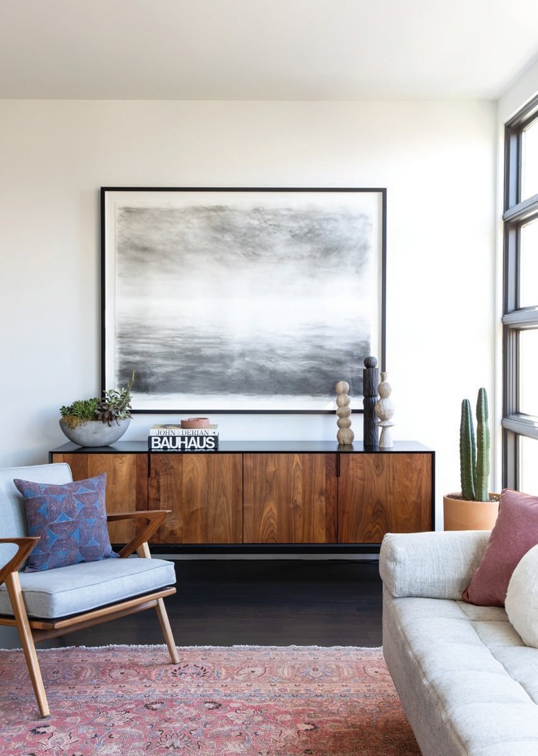 Hung over a credenza by L.A.- based Croft House, “Over Seas” by British painter Sarah Bold commands attention in the living room Photographed by Bess Friday
