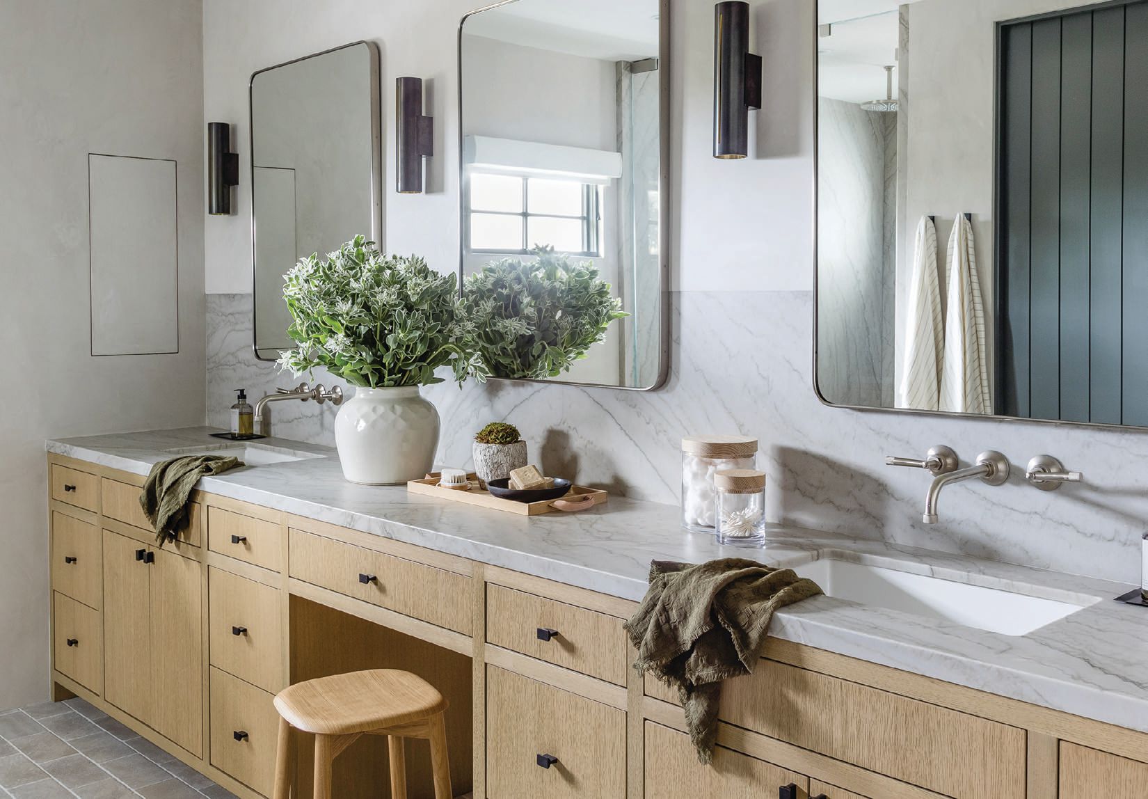 The main bath flaunts a dual vanity with a sea pearl quartzite countertop. PHOTOGRAPHED BY VANESSA LENTINE