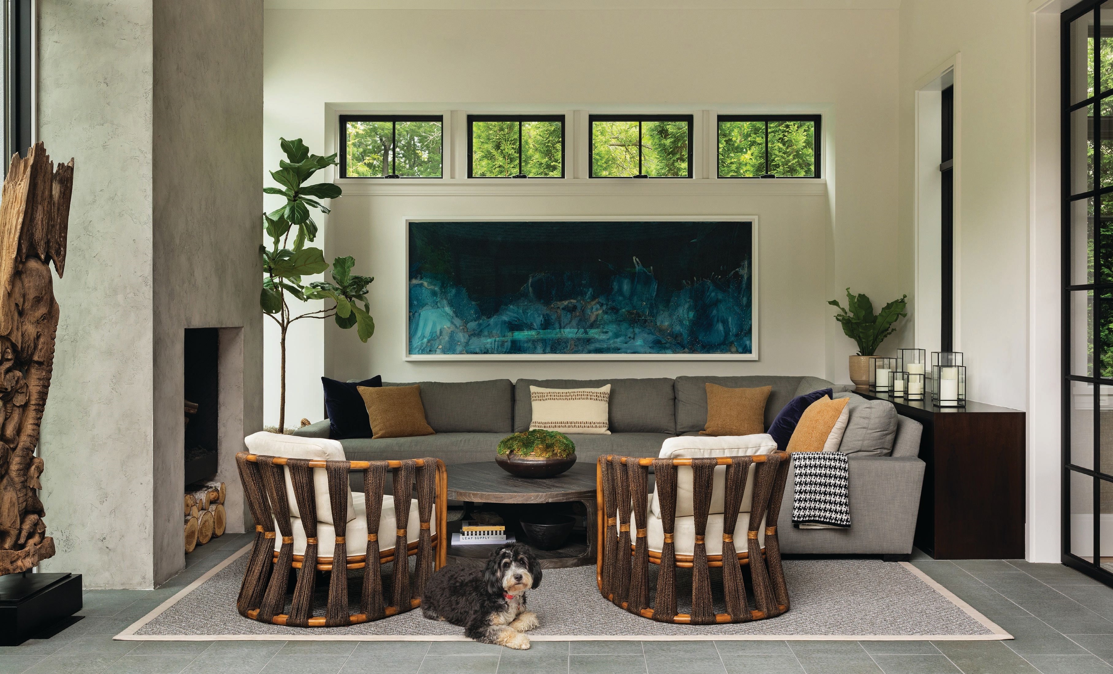 The four seasons room beckons year-round with chic Strings Attached lounge chairs by Palacek, a Maxwell sectional from RH and artist Meghann Riepenhoff’s “Sea Wall Sea Stack II.” Photographed by Aimée Mazzenga