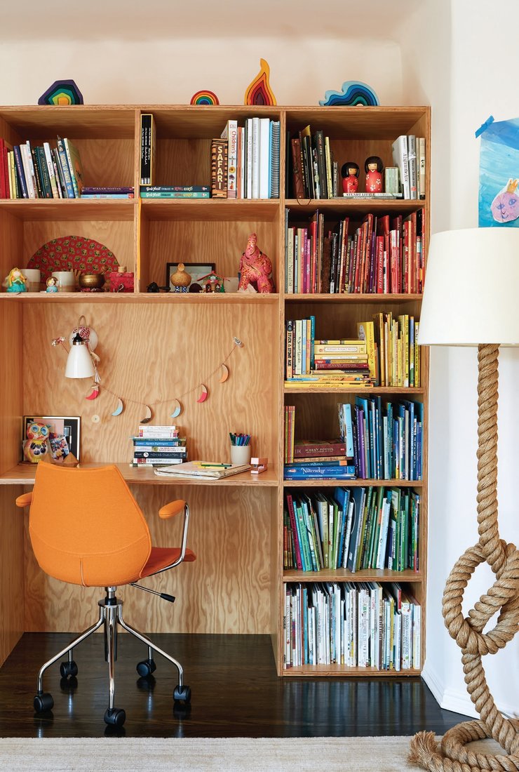 The daughter has several places to herself in the home, including this color-coordinated custom bookshelf-desk. Photographed by Trevor Tondro