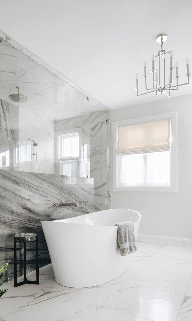 In the primary bath, a gorgeous BainUltra Evanescence tub with Brizo tub filler takes pride of place. PHOTOGRAPHED BY STOFFER PHOTOGRAPHY INTERIORS