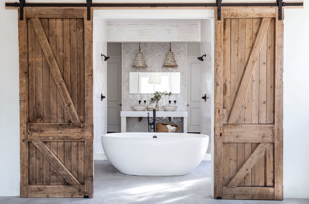 A bath by Leanne Ford Interiors features the Avalon bathtub by Native Trails. PHOTO BY AMY NEUNSINGER