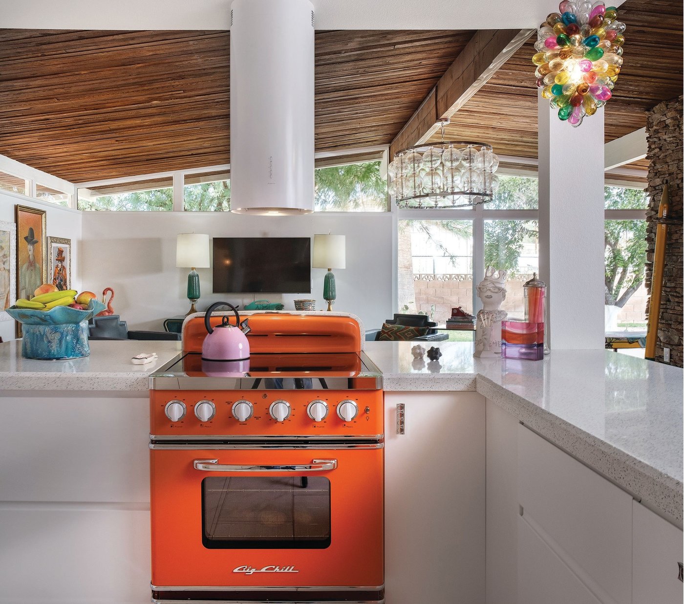 Bold appliances in the kitchen pop against white cabinets Photographed by Michael Woodall