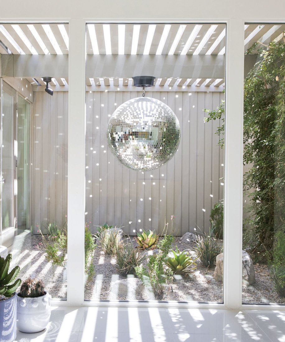 A disco ball lights up the atrium from day to night. PHOTOGRAPHED BY MADELINE TOLLE