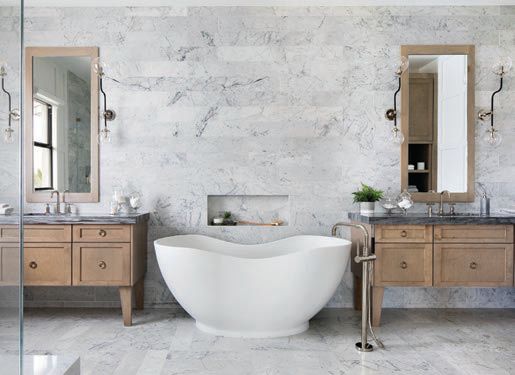 For a new build in Parkland, Fla., Krista Watterworth Alterman designed a spa bathroom covered in floor-to-ceiling marble with a Kohler tub and vanities HOME PHOTO BY JESSICA GLYNN