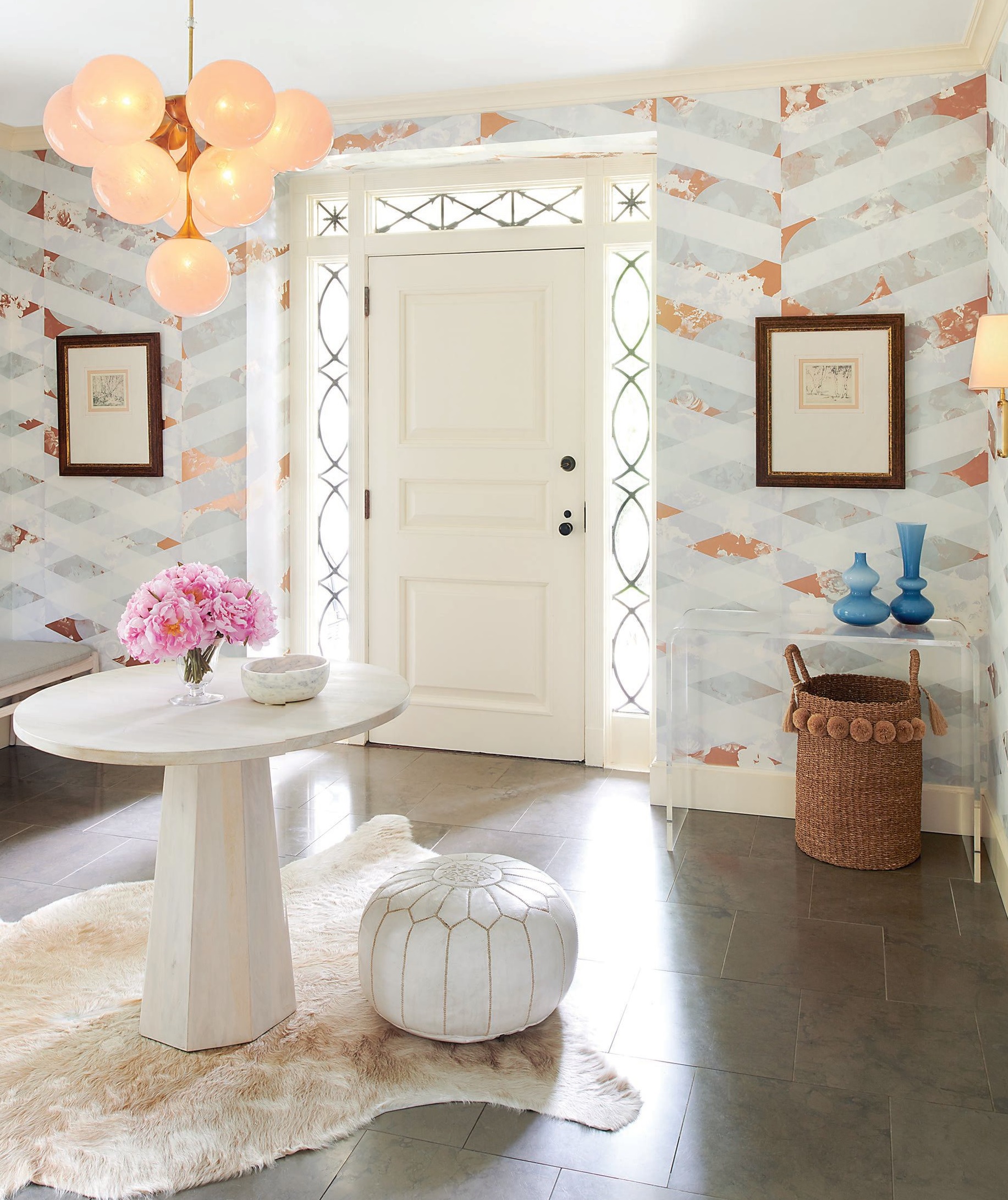 In the entry, wallpaper from Flat Vernacular and a center table from Wisteria. Photographed by Rebecca McAlpin
