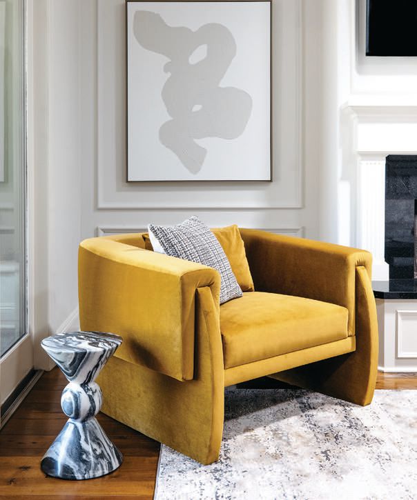 A custom chair in the morning room by Britany Simon Design House pairs beautifully with art by Thom Filicia from Wendover Art Group Photographed by Nick Sorensen