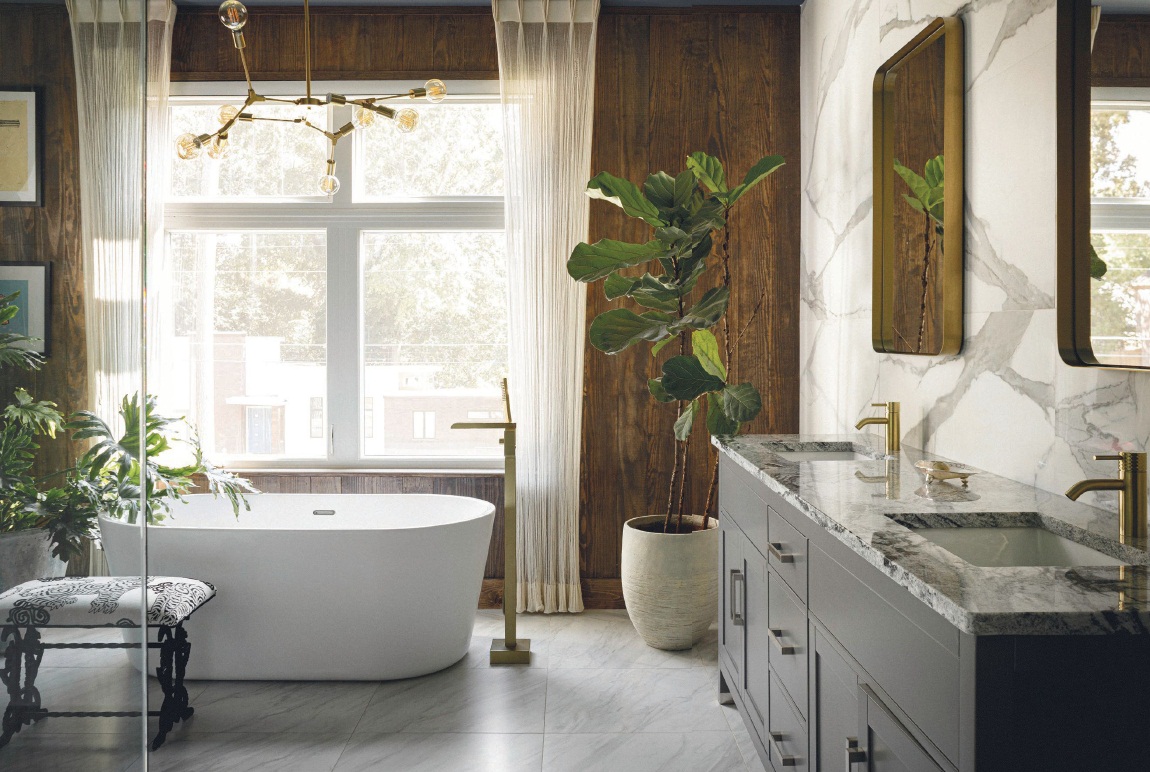 The bathroom features large-format tile sourced from Florida Tile on the walls and Rocky Mountain granite on the countertops. “Its web of beautiful dark veins resemble the Milky Way,” muses designer Ron Jones of R Jones Designs. PHOTO BY MORGAN NOWLAND
