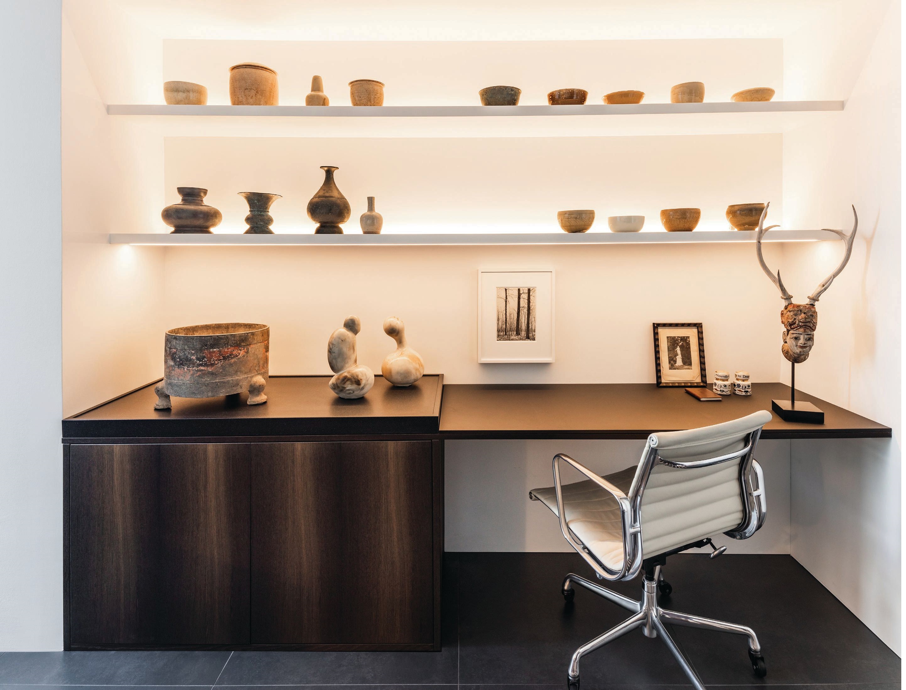 Custom shelving and desk by Boffi Chicago combine with an assortment of antique Vietnamese ceramics and Khmer bronzes to make for a most memorable office workspace. PHOTOGRAPHED BY PETRINI STUDIO