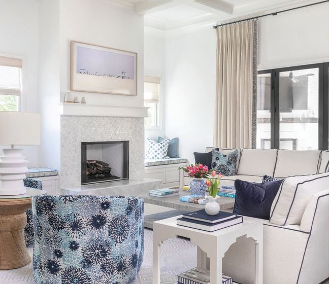 The living room is bright and airy with a sectional and club chairs by The Ellenburg Chair Company in shades of blue Photographed by Heidi Harris Photography
