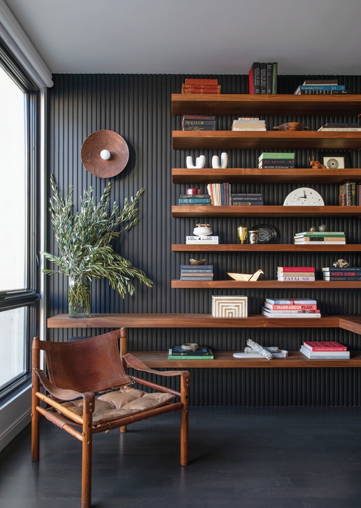 Located right off the dining room, the office, decked out with a custom desk and shelving by Bermosk Woodworks, is decidedly dramatic; Photographed by Bess Friday