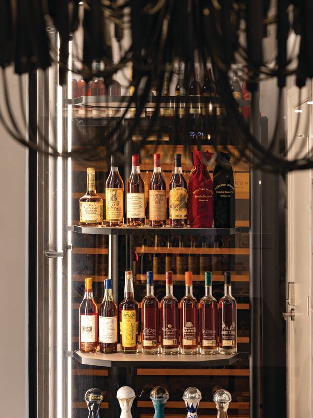 Off the secondary dining room, a deluxe wine room boasts a clear display window to showcase the client’s collection of fine spirits Photographed by Kyle Flubacker