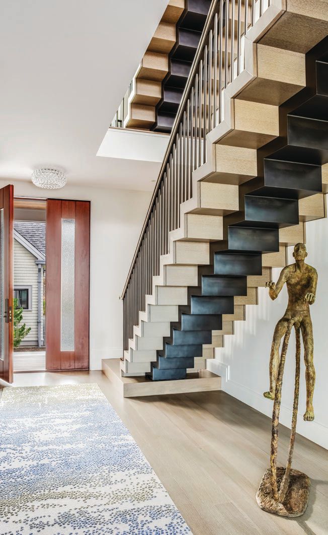 A floating steel and oak staircase in the foyer is truly a work of art—LED lights make the structure hover at night Photographed by Greg Premru Photographed by Greg Premru