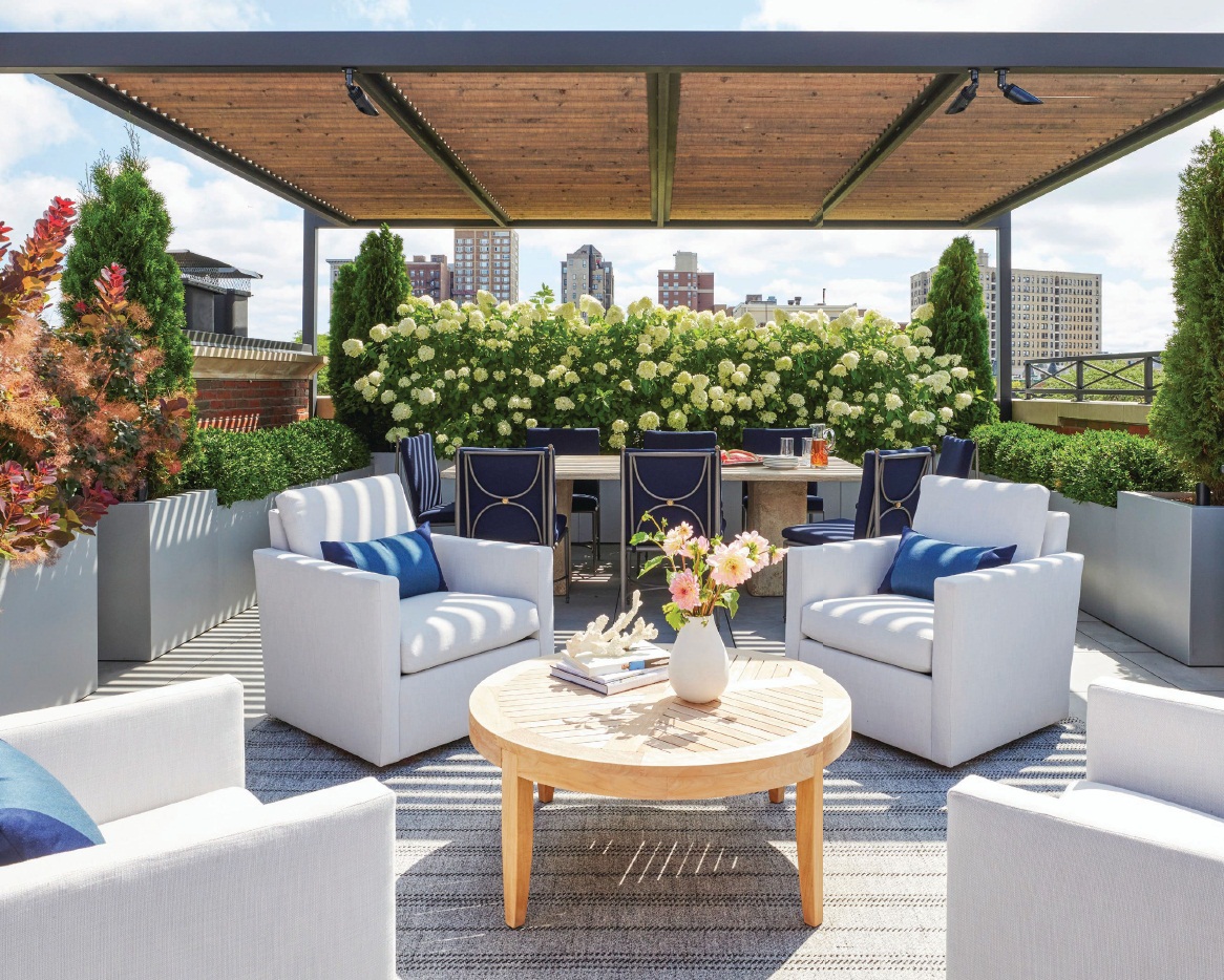 The expansive rooftop is decked out with a dining area featuring a table by Formations and chairs by Summer Classics, plus a seating area with swiveling lounge chairs by Century Furniture HOME STYLING BY HILARY ROSE Photographed by Werner Straube