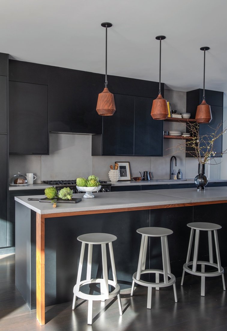 Like the rest of the home, the kitchen contains a mix of black and white elements mixed with earthy textures. The Ikea cabinets are equipped with Semihandmade doors in Supermatte Black Slab, while the counters and backsplash are by Concrete Interiors Photographed by Bess Friday