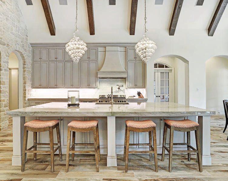 The kitchen’s sky-high beams help open up the space. PHOTO COURTESY OF COMPASS