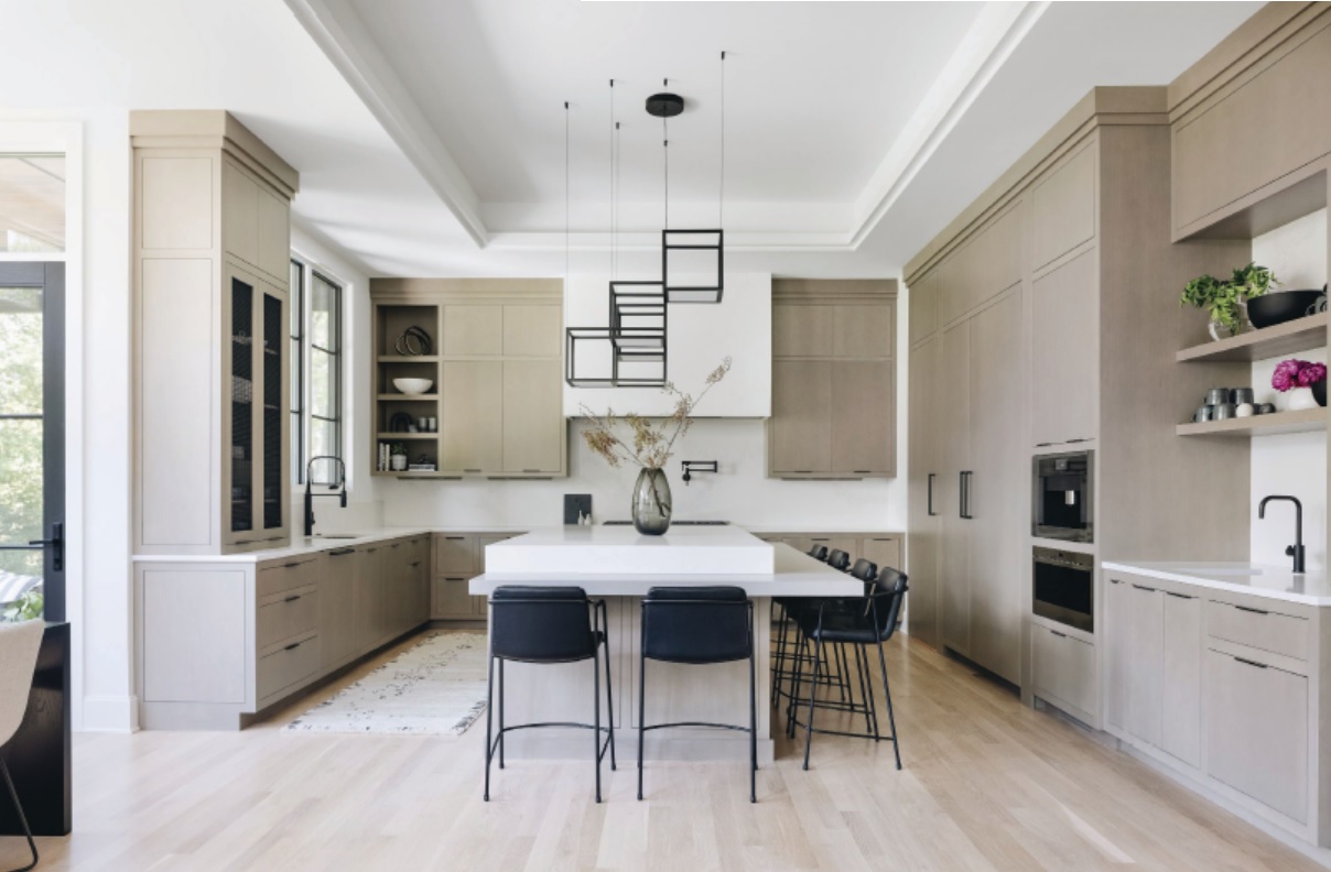 Boasting custom cabinets by Wood Quality Cabinets and stylish lighting by Sonneman, the kitchen is a natural gathering spot. Photographed by Stoffer Photography Interiors