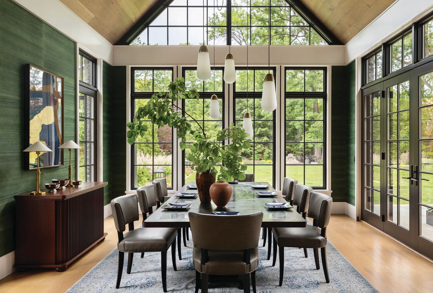 Walls of windows in the dining room let the outdoors in Photographed by Aimée Mazzenga