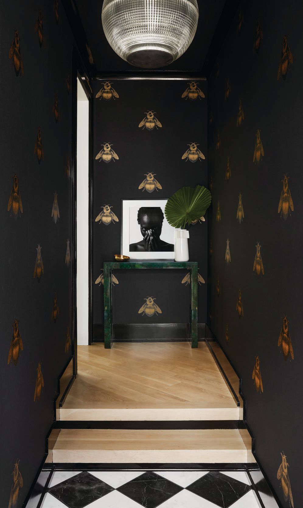 Showstopping Napoleon Bee wallpaper by Timorous Beasties, a striking portrait by David Allan Brandt and chic checkerboard flooring by Renaissance Tile & Bath add up to a wow-worthy entry. PHOTOGRAPHED BY DUSTIN HALLECK
