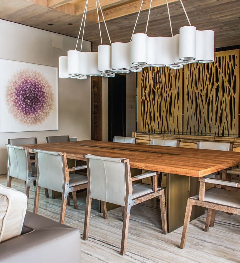 Ted Abramczyk’s Linear Cumulus light fixtures, purchased through Ralph Pucci, dangle above a long dining table designed by Hamui. The dining chairs were discovered at Holly Hunt PHOTOGRAPHED BY ADRIANA HAMUI