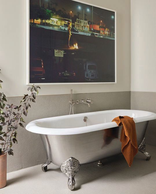 an Alex Prager artwork hangs over a Drummonds Bathrooms’ Spey tub. PHOTOGRAPHED BY MIKE SCHWARTZ 