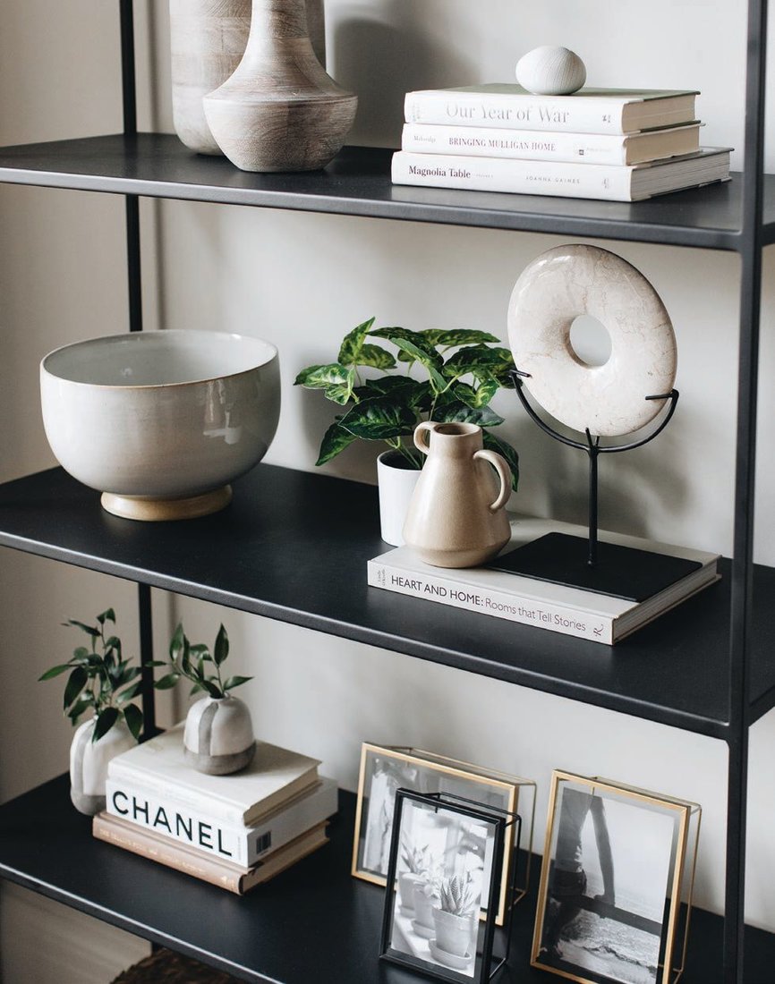 A hypercurated selection of accessories dots shelving in the family room PHOTOGRAPHED BY STOFFER PHOTOGRAPHY INTERIORS
