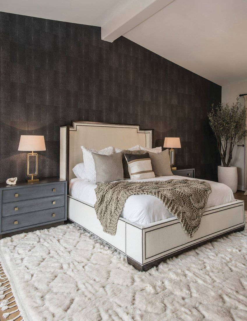 A shagreen wallcovering serves as a warm backdrop to the primary bedroom. Photographed by Scott Sandler